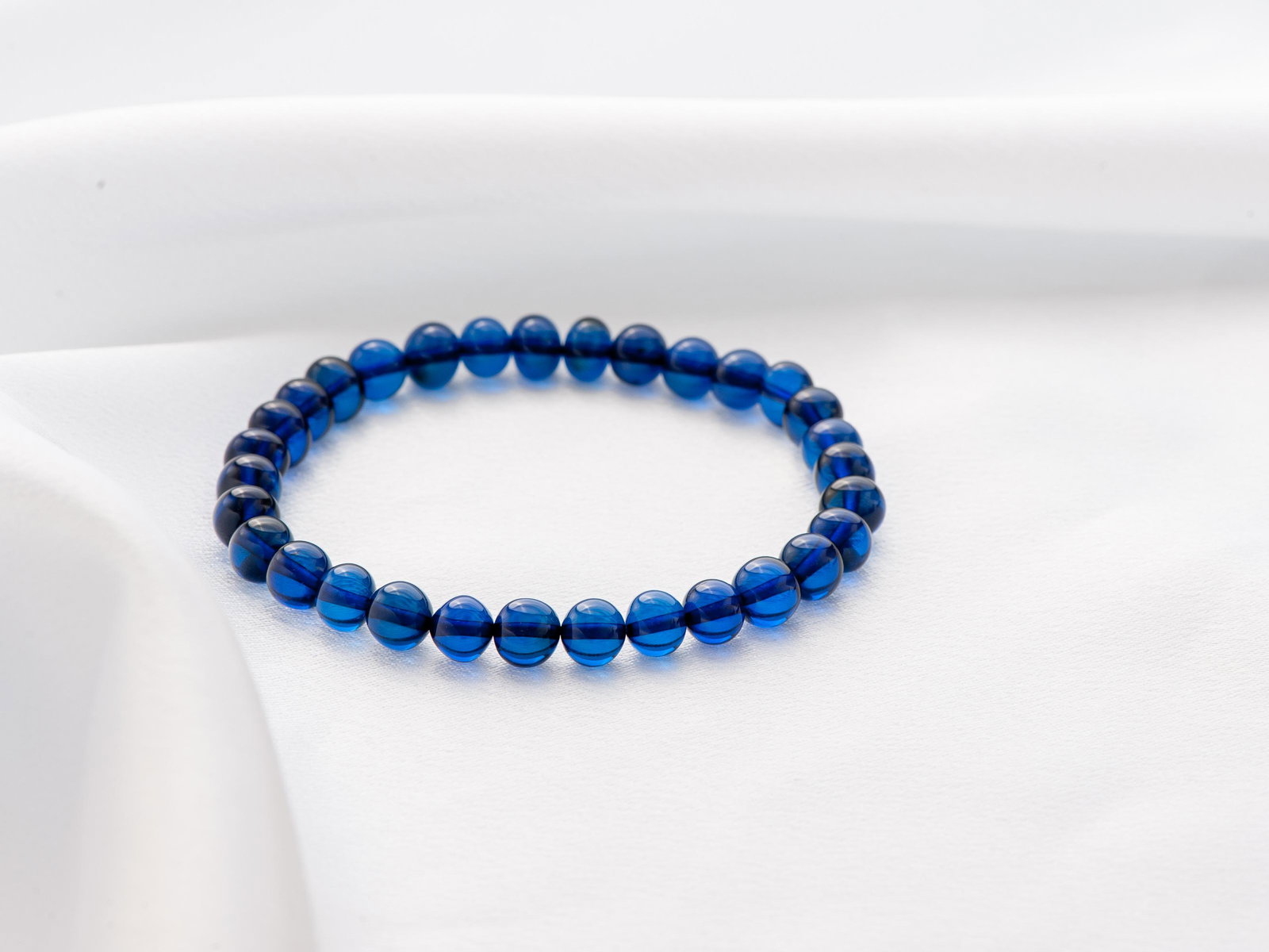 Blue Amber Bracelet made of irregular shape ball beads: Title: Blue Amber Bracelet made of irregular shape ball beads Materials: Blue amber Weight in grams: 6 Additional Information: Amber bracelet made from irregular shape round blue amber beads. Unisex a
