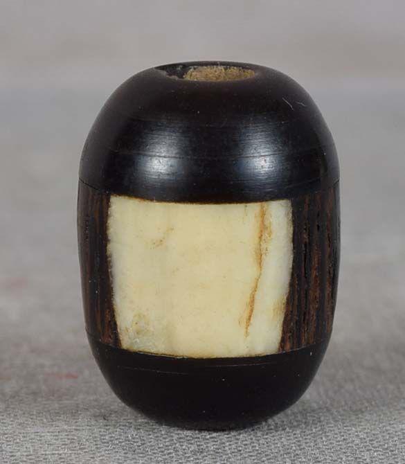19c OJIME netsuke slide staghorn//rosewood/buffalo horn: 19th century ojime (slide bead for tightening the cord going from netsuke to inro) in seed form made out of one layer of rosewood flanked by layers of staghorn and that assembly sandwiched between buf