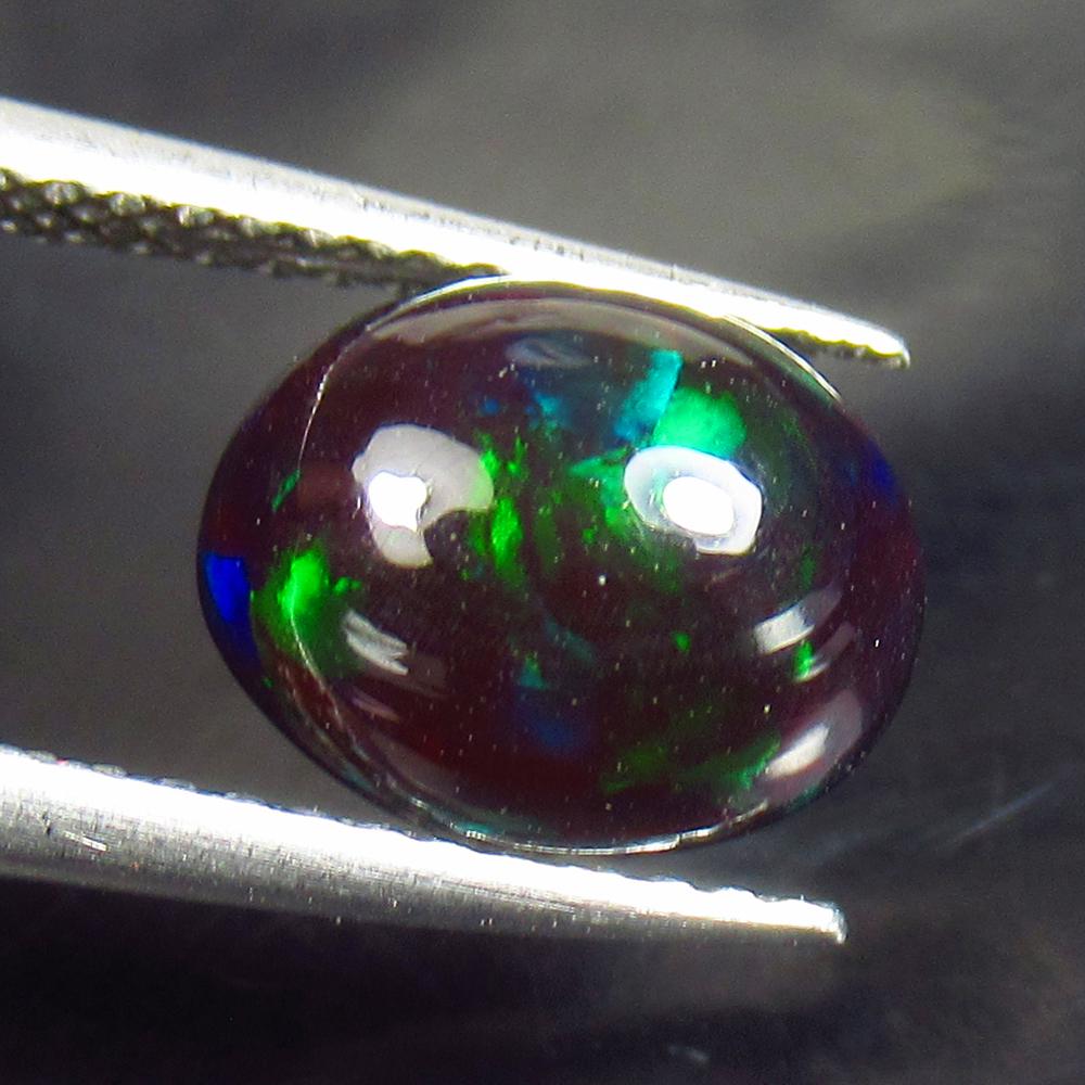 1.56 Ctw Natural Ethiopian Black Fire Opal Oval Cab: No Reserve! Title: 1.56 Ctw Natural Ethiopian Black Fire Opal Oval Cab Stone Clarity: Translucent Gemstones: Black Opal Carat Weights: 1.56 Size/Dimensions: 9.50 x 7.60 x 4.80 mm Additional Informatio