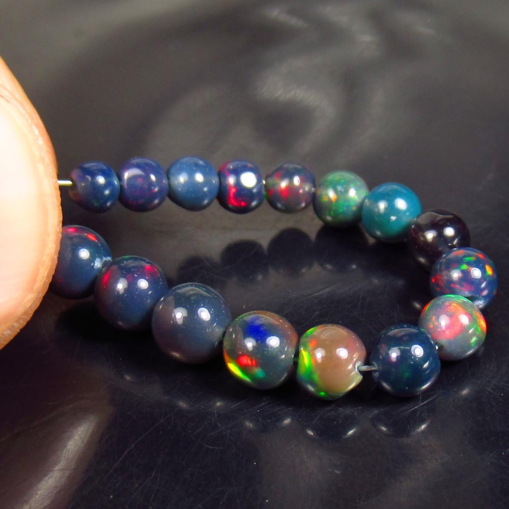 13.40 Ctw Natural 16 Drilled Black Fire Opal Ball Beads: No Reserve! Title: 13.40 Ctw Natural 16 Drilled Black Fire Opal Ball Beads Stone Clarity: Translucent Gemstones: Black Opal Beads Carat Weights: 13.4 Size/Dimensions: 3.00 to 4.30 mm / 16 PC's Additio