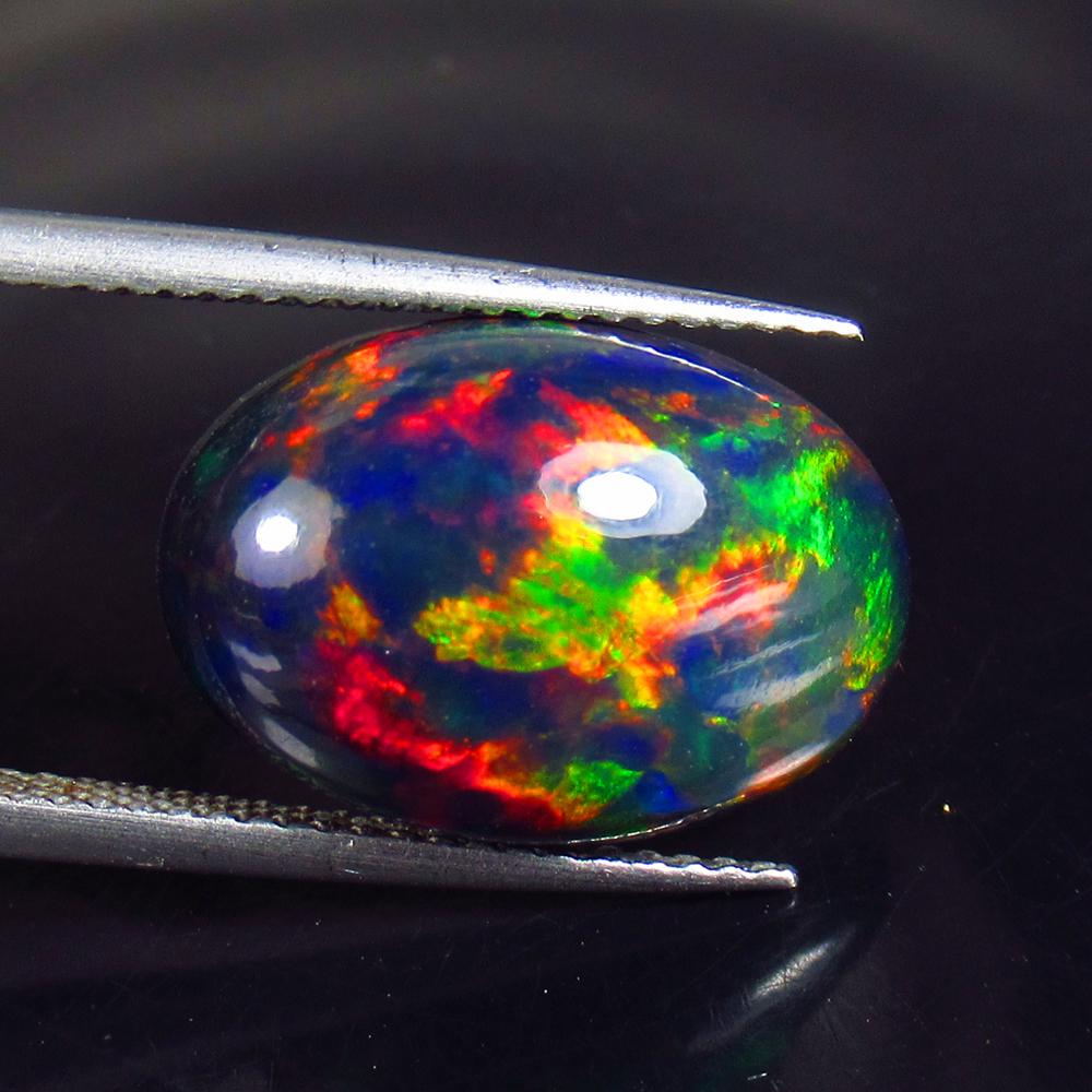 5.54 Ctw Natural Ethiopian Black Fire Opal Oval Cab: Title: 5.54 Ctw Natural Ethiopian Black Fire Opal Oval Cab Stone Clarity: Opaque Gemstones: Black Opal Carat Weights: 5.54 Size/Dimensions: 16.50 x 11.40 x 6.20 mm Additional Information: Excellent Ov