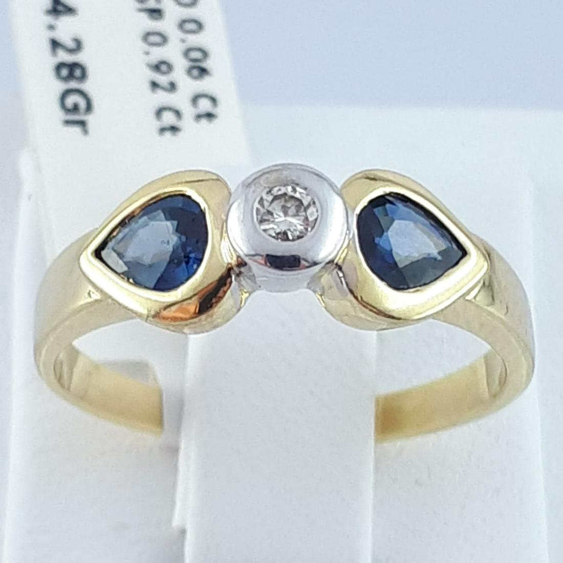 14K Yellow Gold - Ring: Ring Gender : Women Material : 14K Yellow Gold Diamond : 1 Brillant cut, 0,06 ct H colour, VS clarity Sapphire : 2 pcs pear cut natural sapphire, total 0,92 ct Weight : 4,3 gr Condition : Used but in