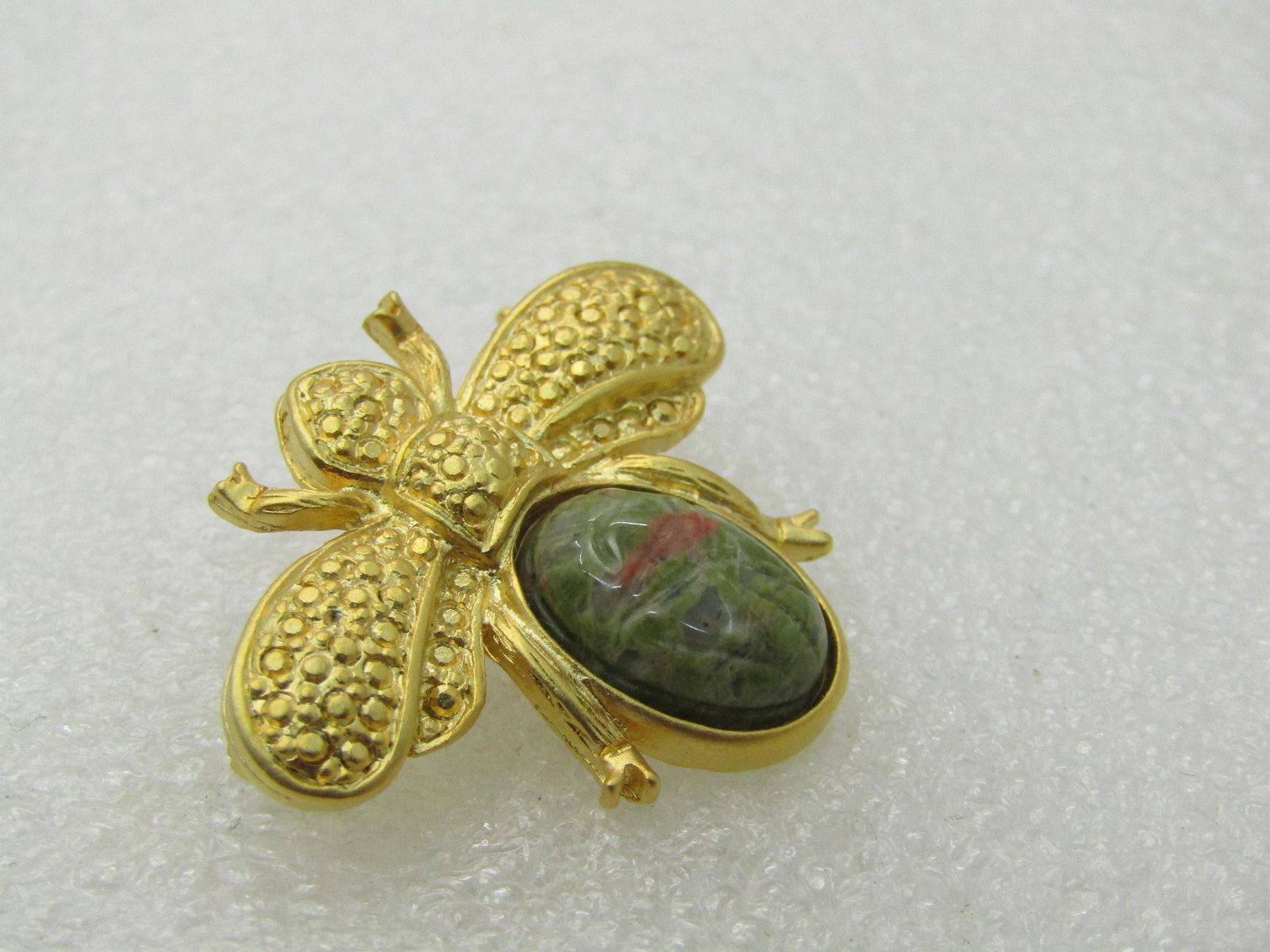 Vintage Egyptian Scarab Beetle Brooch Gold Tone 1.25: Vintage Egyptian Unakite Scarab Beetle Brooch, Gold Tone, 1.25" Wide and 1-1/8" long. This has a textured body - the body looks like a beetle or a fly but has a unakite scarab as the rounded back. It 