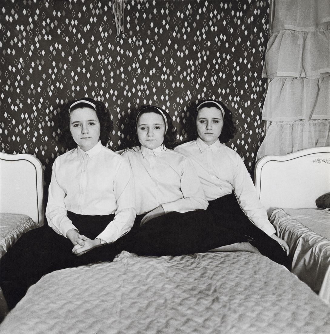 DIANE ARBUS - Triplets In Their Bedroom, NJ, 1963: Aritst: Diane Arbus Title: Triplets In Their Bedroom, NJ, 1963 Medium: Photo Litho, 1972, USA Dimensions: 8.3x8.4" Description: Heat Wax Mounted on 11x14" Conservation Board Artist Bio: Diane Arbus wa