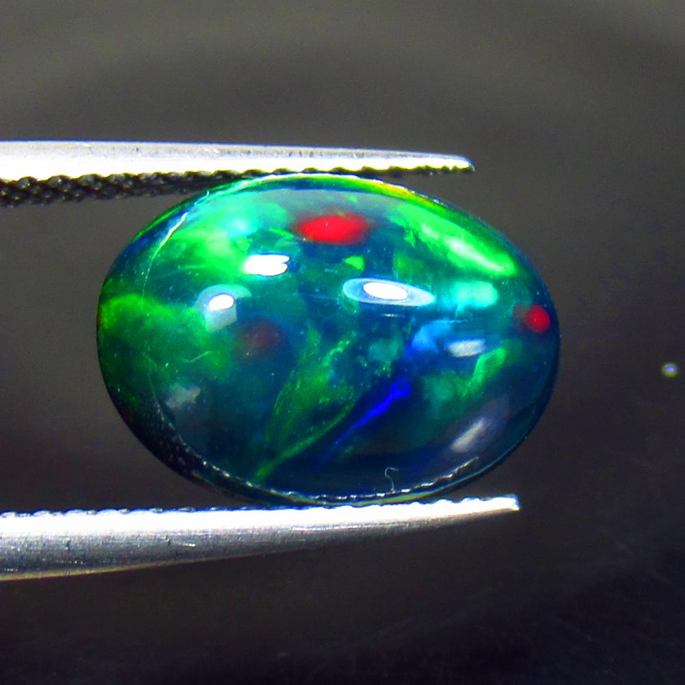 3.30 Ctw Natural Black Fire Opal Oval Cabochon: Title: 3.30 Ctw Natural Black Fire Opal Oval Cabochon Clarity: Semi - Transparent Gemstone: Natural Opal Carat Weight: 3.3 Dimensions: 13.30 x 9.60 x 6.10 mm Additional Information: Shape - Oval Caboc