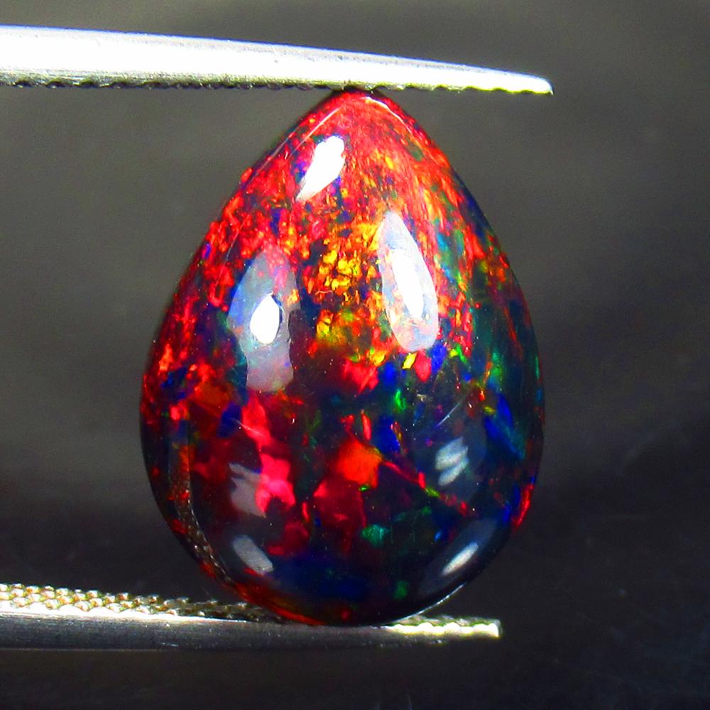 4.71 Ctw Natural Black Fire Opal Pear Cabochon: Title: 4.71 Ctw Natural Black Fire Opal Pear Cabochon Clarity: Semi - Transparent Gemstone: Natural Opal Carat Weight: 4.71 Dimensions: 15.10 x 11.30 x 6.20 mm Additional Information: Shape - Pear Cab