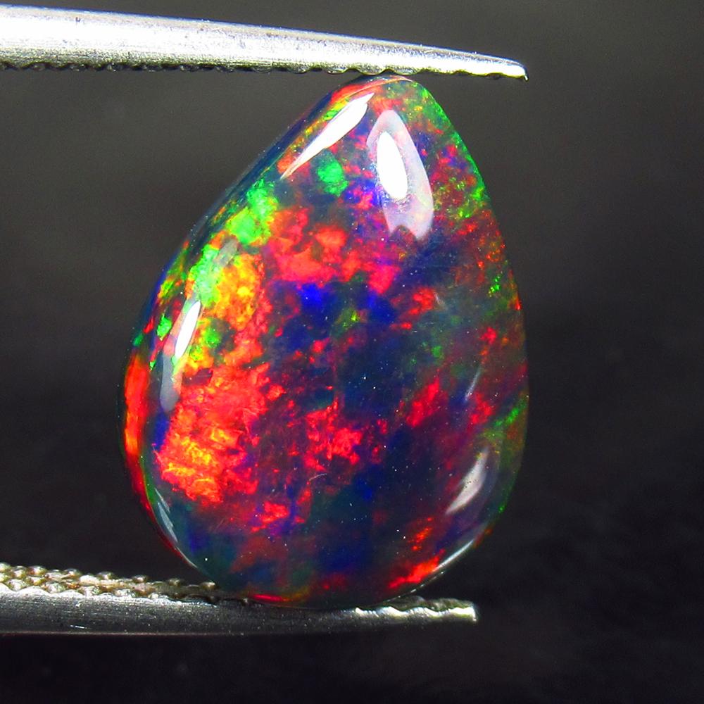 2.60 Ctw Natural Black Fire Opal Pear Cabochon: Title: 2.60 Ctw Natural Black Fire Opal Pear Cabochon Clarity: Opaque Gemstone: Natural Opal Carat Weight: 2.6 Dimensions: 13.00 x 9.90 x 3.70 mm Additional Information: Shape - Pear Cabochon / Color 