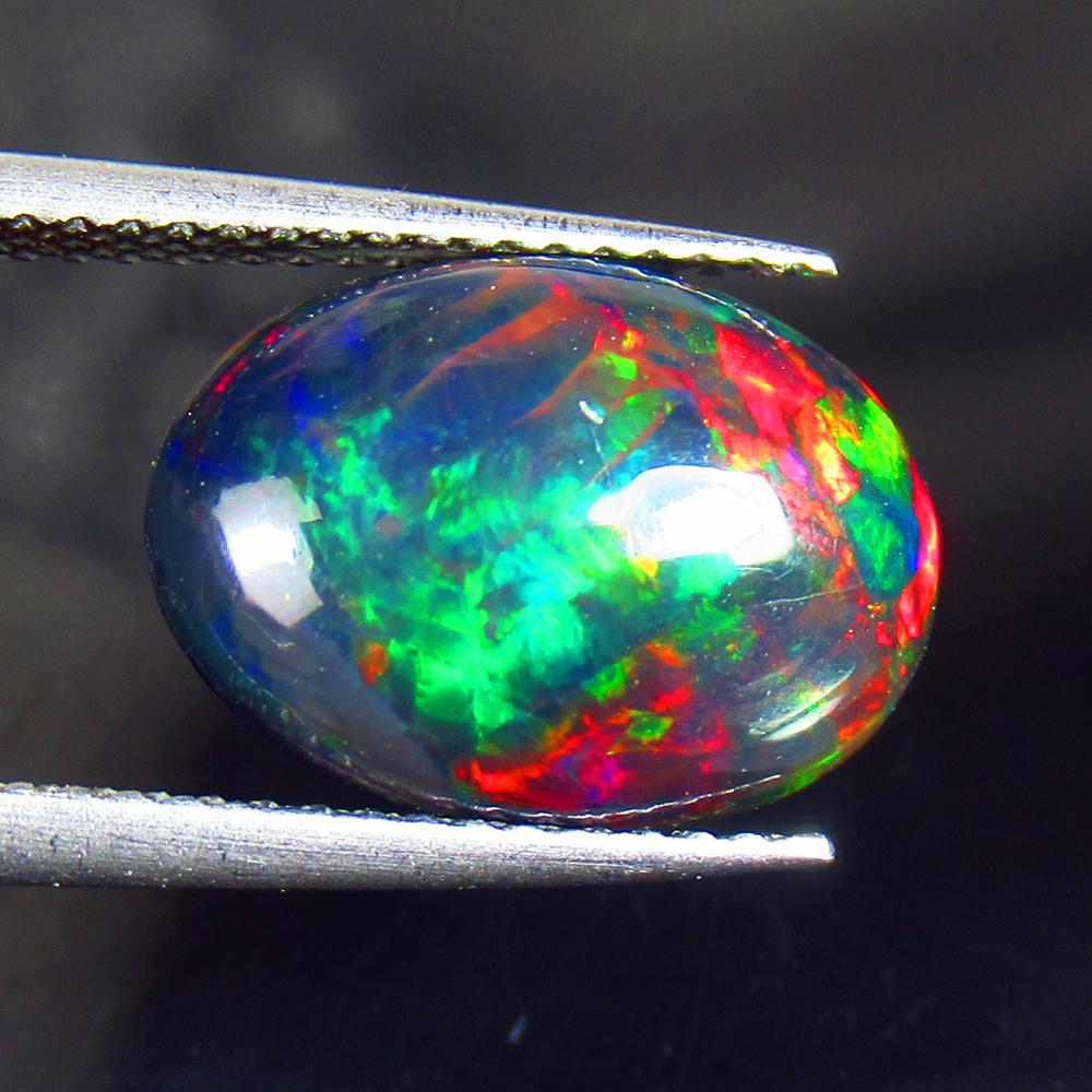 2.88 Ctw Natural Black Fire Opal Oval Cabochon: Title: 2.88 Ctw Natural Black Fire Opal Oval Cabochon Clarity: Opaque Gemstone: Natural Opal Carat Weight: 2.88 Dimensions: 13.80 x 10.00 x 4.50 mm Additional Information: Shape - Oval Cabochon / Colo