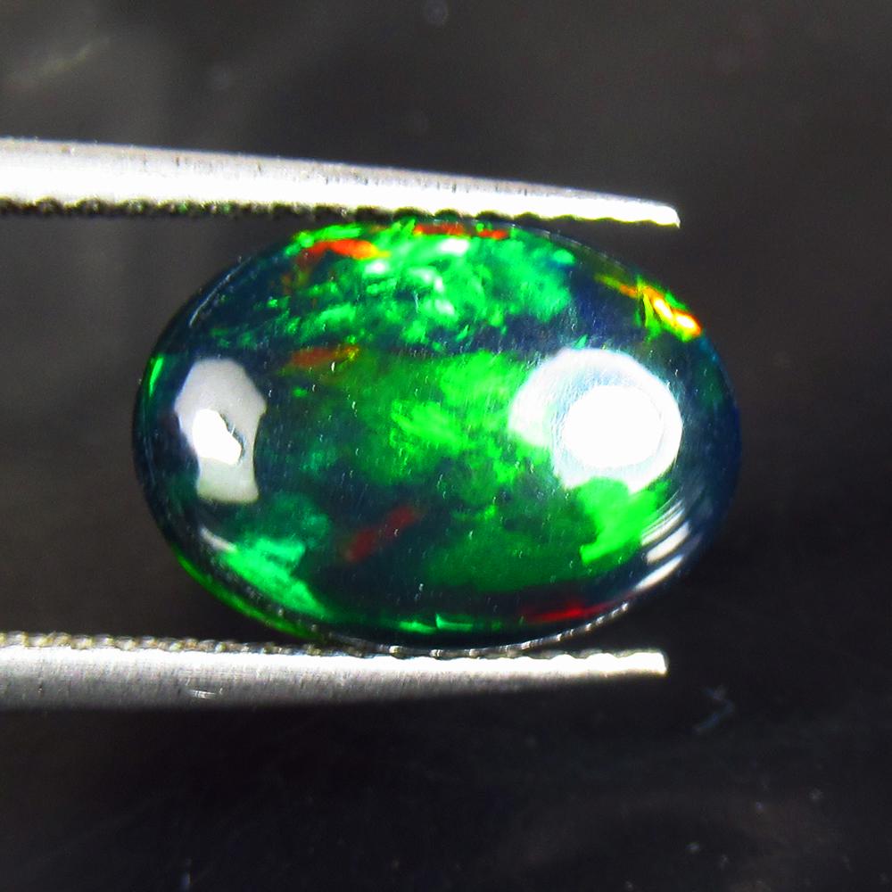 1.88 Ctw Natural Black Fire Opal Oval Cabochon: Title: 1.88 Ctw Natural Black Fire Opal Oval Cabochon Clarity: Opaque Gemstone: Natural Opal Carat Weight: 1.88 Dimensions: 12.80 x 9.20 x 3.40 mm Additional Information: Shape - Oval Cabochon / Color