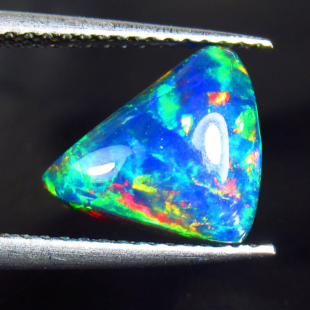 1.83 Ctw Natural Black Fire Opal Trillion Cabochon: Title: 1.83 Ctw Natural Black Fire Opal Trillion Cabochon Clarity: Opaque Gemstone: Natural Opal Carat Weight: 1.83 Dimensions: 10.70 x 8.20 x 4.50 mm Additional Information: Shape - Pear Cabochon / C