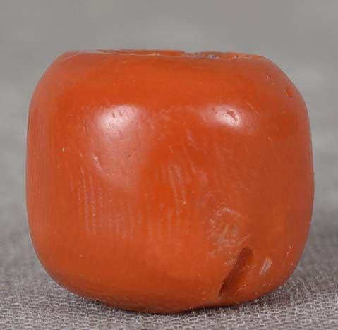 19c CORAL OJIME netsuke cord slide: 19th century coral ojime (slide bead for tightening the cord going from netsuke to inro) of simple barrel shape. True coral of beautiful deep red natural color (not stained), natural porous areas arou