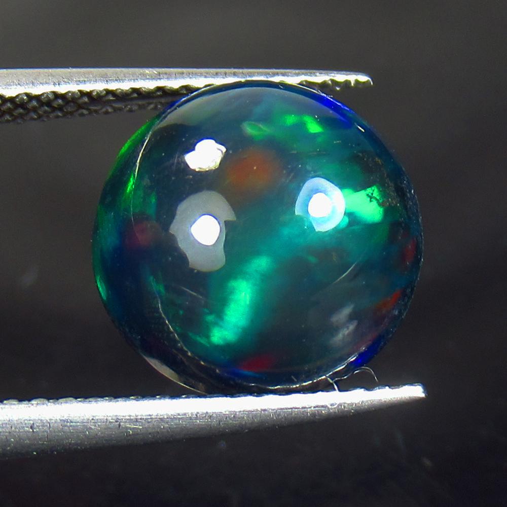 3.84 Ctw Natural Ethiopian Black Fire Opal Round Cab: No Reserve! Title: 3.84 Ctw Natural Ethiopian Black Fire Opal Round Cab Stone Clarity: Opaque Gemstones: Natural Black Opal Carat Weights: 3.84 Size/Dimensions: 11.00 x 11.00 x 6.50 mm Additional Info
