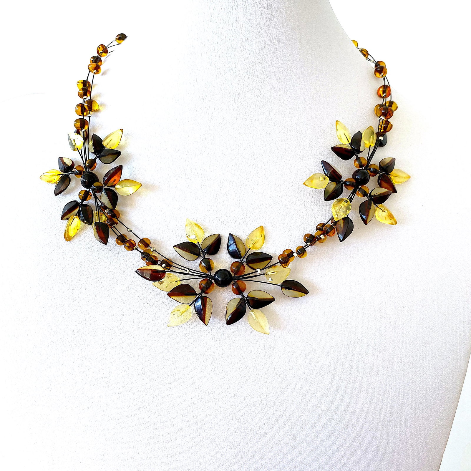 Exquisite Amber Floral Necklace made from leaf like bead ornaments: Title: Exquisite Amber Floral Necklace made from leaf like bead ornaments Metal: None Gemstones: Amber Weight: 12.0 g Size: Size: 44.0 x 5.0 x 420.0 mm Size: 1.732 x 0.197 x 16.535 inches Made of: Who