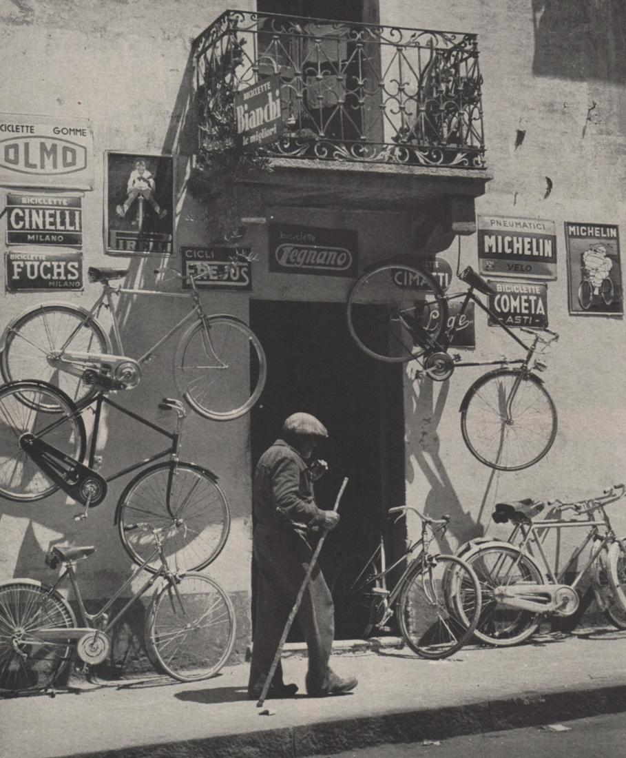 WOLFGANG SUSCHITZKY - Bicycle Shop ca 1950s: Artist: WOLFGANG SUSCHITZKY Print Title: Bicycle Shop ca 1950s Medium: Photoengraving Printed 1950s in the USA Image size (inches) approx. 8.5 x 7” Reserve: $30.00 Shipping: Domestic: Flat-rate
