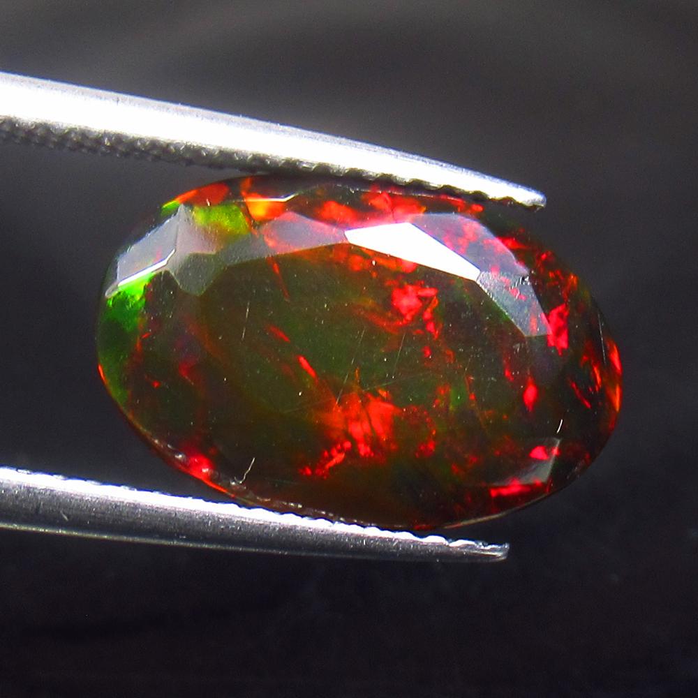 2.95 Ctw Natural Black Fire Opal: Title: 2.95 Ctw Natural Black Fire Opal Stone Clarity: Translucent Gemstones: Natural Opal Carat Weights: 2.95 Size/Dimensions: 14.00 x 9.20 x 5.50 mm Additional Information: Shape - Oval Cut / Color 