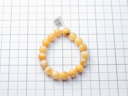 Natural Baltic amber bracelet made of 12mm ball beads: Title: Natural Baltic amber bracelet made of 12mm ball beads Materials: Baltic amber Weight: 16.13 Additional Information: Genuine Baltic amber bracelet made of butterscotch amber 12mm beads.