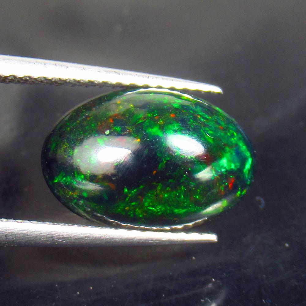 2.66 Ctw Natural Ethiopian Black Fire Opal Oval Cab: No Reserve! Title: 2.66 Ctw Natural Ethiopian Black Fire Opal Oval Cab Stone Clarity: Translucent Gemstones: Black Opal Carat Weights: 2.66 Size/Dimensions: 13.40 x 8.*90 x 5.30 mm Additional Informat