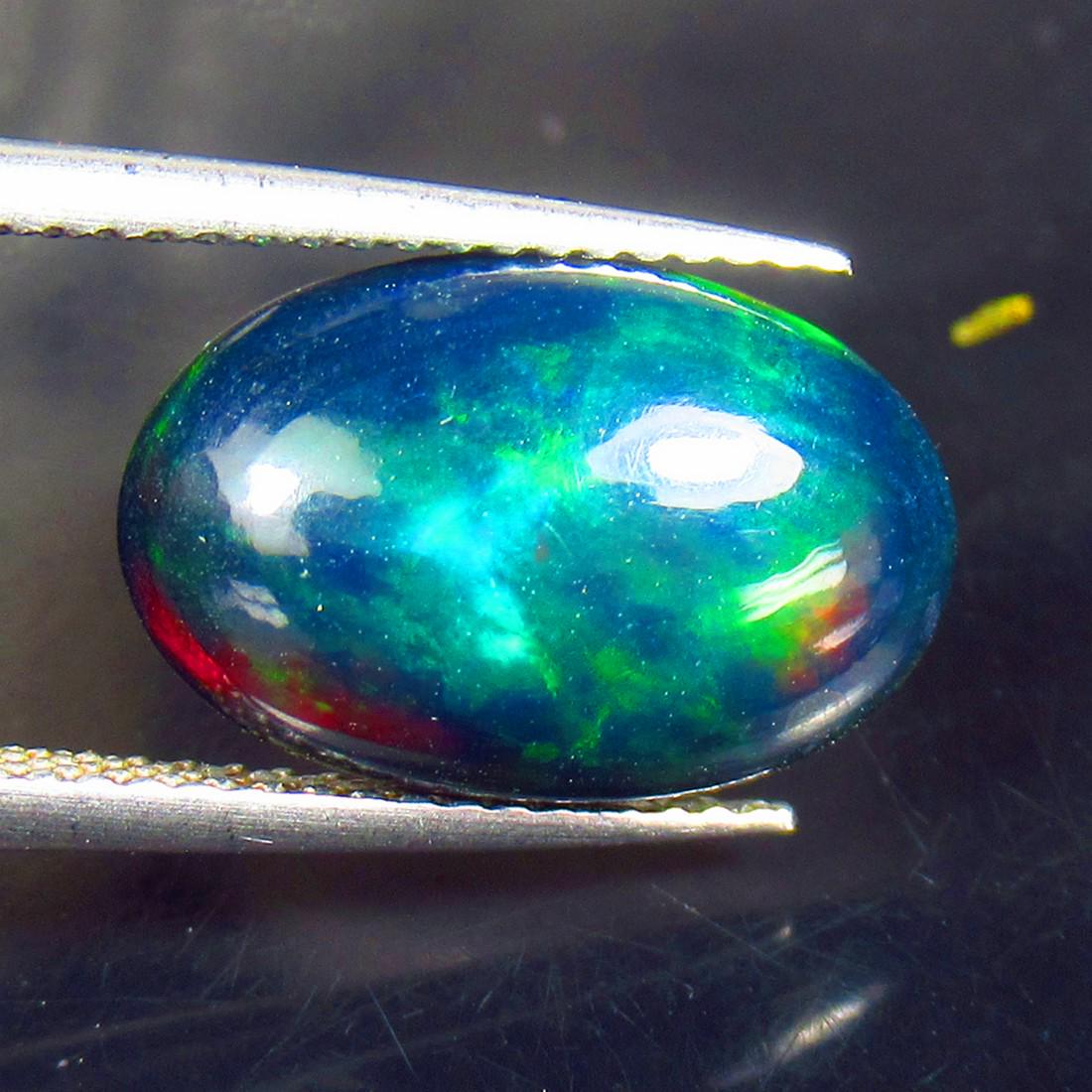 3.36 Ctw Natural Ethiopian Black Fire Opal Oval Cab: No Reserve! Title: 3.36 Ctw Natural Ethiopian Black Fire Opal Oval Cab Stone Clarity: Translucent Gemstones: Natural Black Opal Carat Weights: 3.36 Size/Dimensions: 14.90 x 9.60 x 5.00 mm Additional I