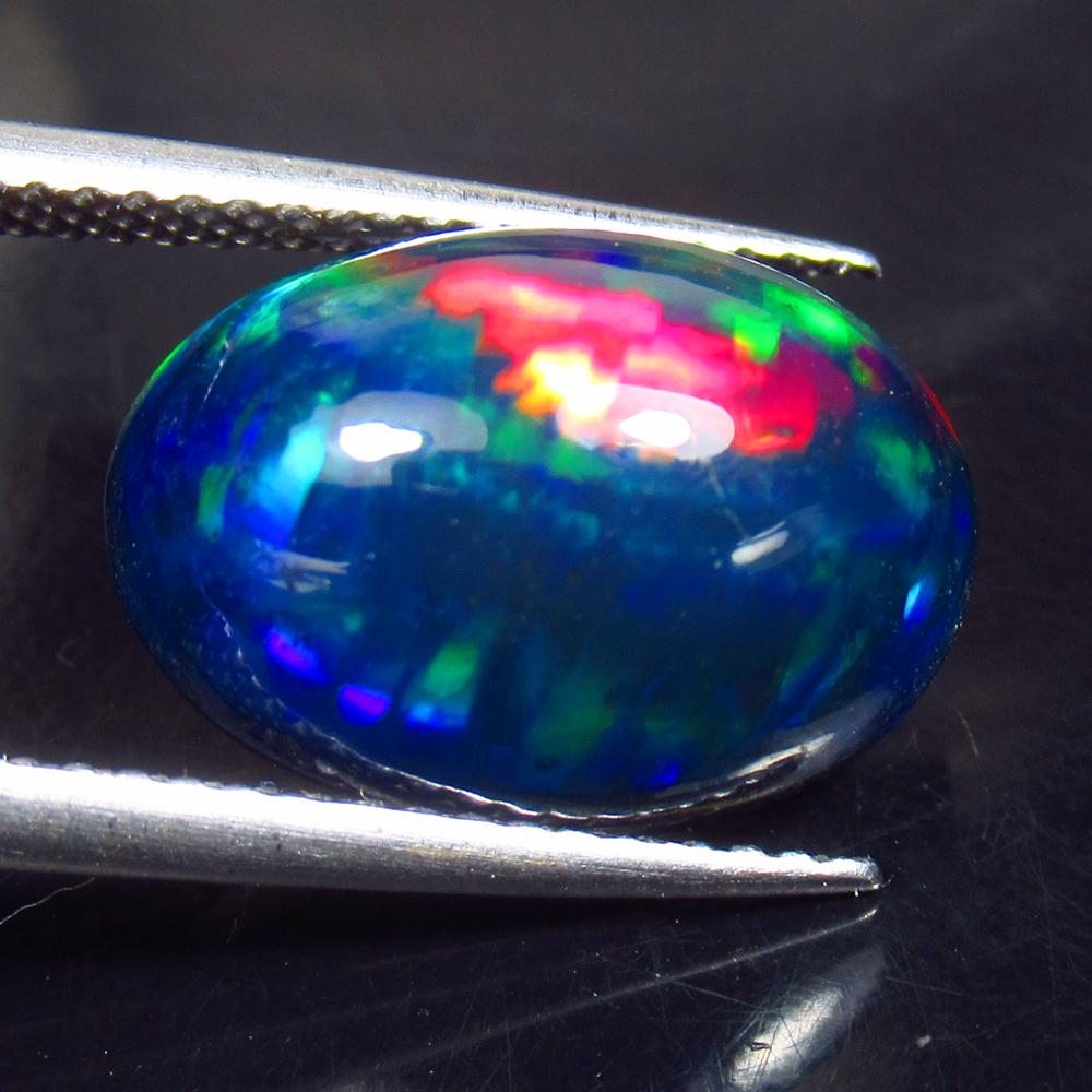 4.66 Ctw Natural Black Fire Opal Oval Cabochon: Title: 4.66 Ctw Natural Black Fire Opal Oval Cabochon Stone Clarity: Semi - Transparent Gemstone: Natural Opal Carat Weight: 4.66 Size/Dimensions: 14.70 x 10.20 x 7.00 mm Additional Information: Shape