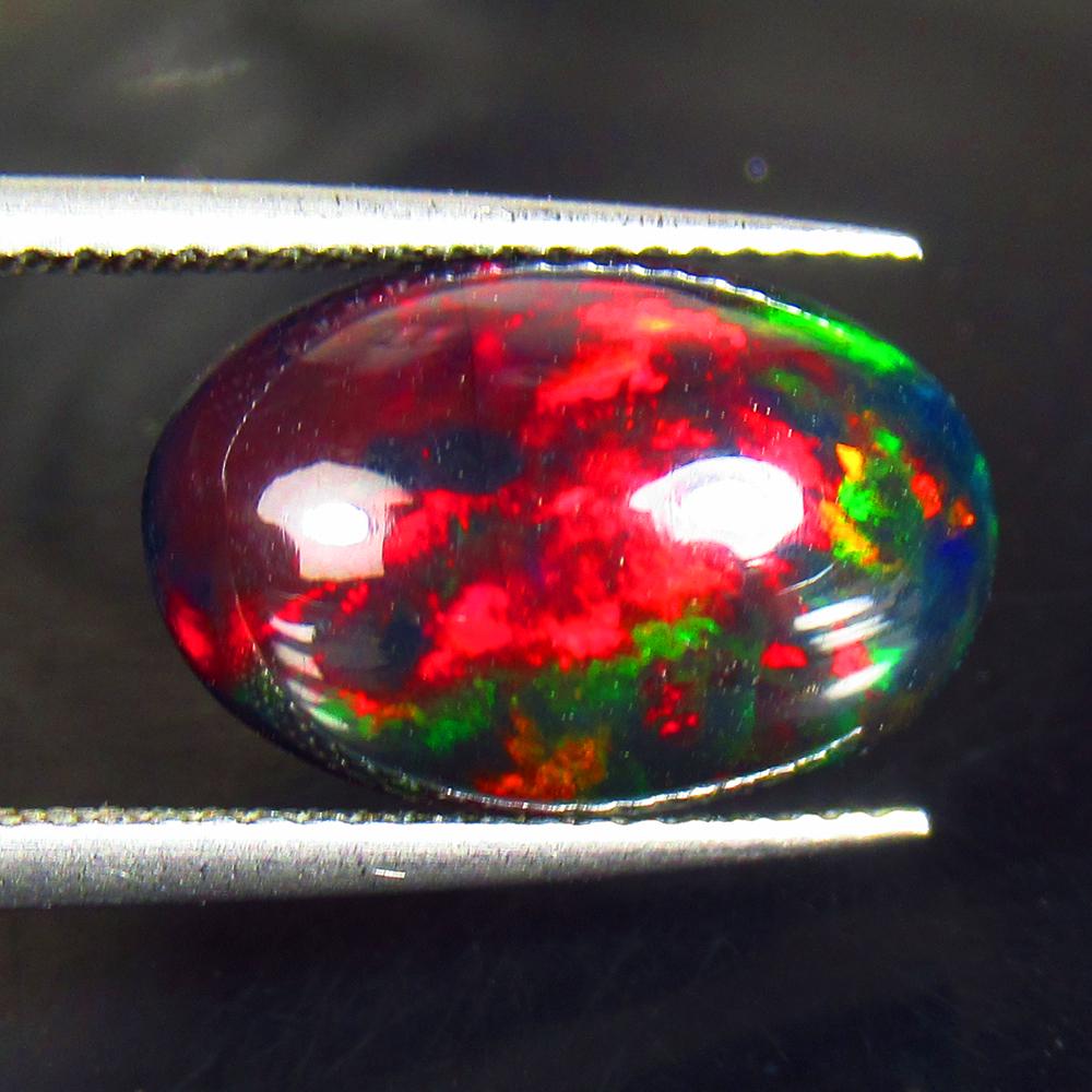 3.96 Ctw Natural Black Fire Opal Oval Cabochon: Title: 3.96 Ctw Natural Black Fire Opal Oval Cabochon Stone Clarity: Opaque Gemstone: Natural Opal Carat Weight: 3.96 Size/Dimensions: 15.30 x 9.80 x 6.50 mm Additional Information: Shape - Oval Caboc