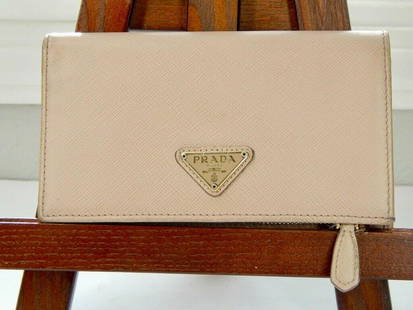 Prada Blush Pink Leather Long Wallet: Title: Prada Blush Pink Leather Long WalletSize: One sizeAdditional Information: Pre-owned PRADA Mauve/pink folding wallet Two snap closure folding sides Front logo has minor scratching and rubbing