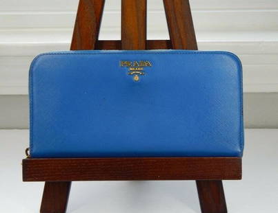 Prada Periwinkle Leather Long Wallet: Title: Prada Periwinkle Leather Long WalletSize: One sizeAdditional Information: Pre-owned PRADA Periwinkle blue leather long wallet Exterior shows some wear All four corners have rubbing There are