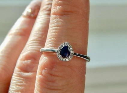 18K Solid White Gold sapphire and Diamond Pear Cut Ring: Title: 18K Solid White Gold sapphire and Diamond Pear Cut RingSize: 6.75Additional Information: Gorgeous 18K white gold Sapphire and Diamond halo ring Size 6.75 Sapphire is pear cute at .39ctw With