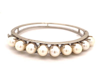 Vintage 9 Pearl 14K White Gold Bangle Bracelet: This is a beautiful vintage bracelet set with 9 pearls in white gold c.1970. The pearls have amazing color and luster and they are evenly matched. The pearls measure 7.5mm in diameter. The bracelet