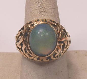 Beautiful Unique 14K Gold Ring Set With A Large Opal Doublet 5 Carats: Vintage Unique Large 14K Gold Ring Set With A Large Opal Doublet Measuring 5 Carats. The condition is excellent. Ring Size 9-3/4 weight 14.7 grams. from the top of the opal to the bottom of the ring