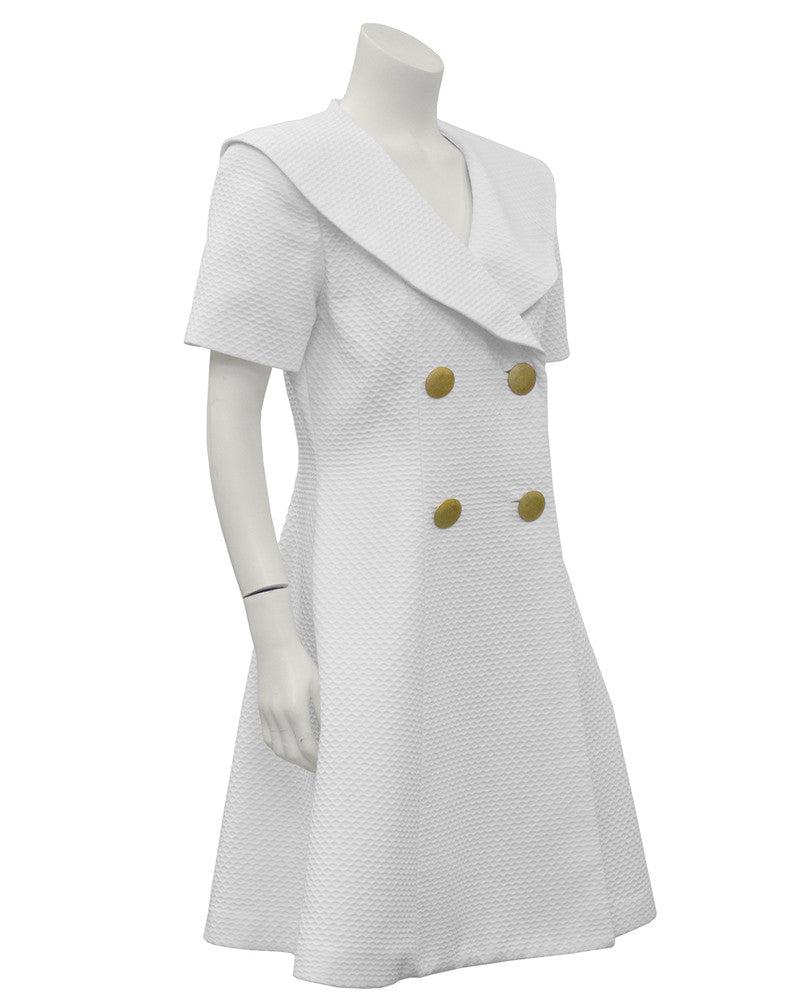 Scaasi White Pique Double Breasted Dress: Scaasi white pique double breasted daydress from the 1980's. Sailor style collar accentuates the V neckline, four textured goldtone buttons at the front and a full skirt. In excellent condition, marke