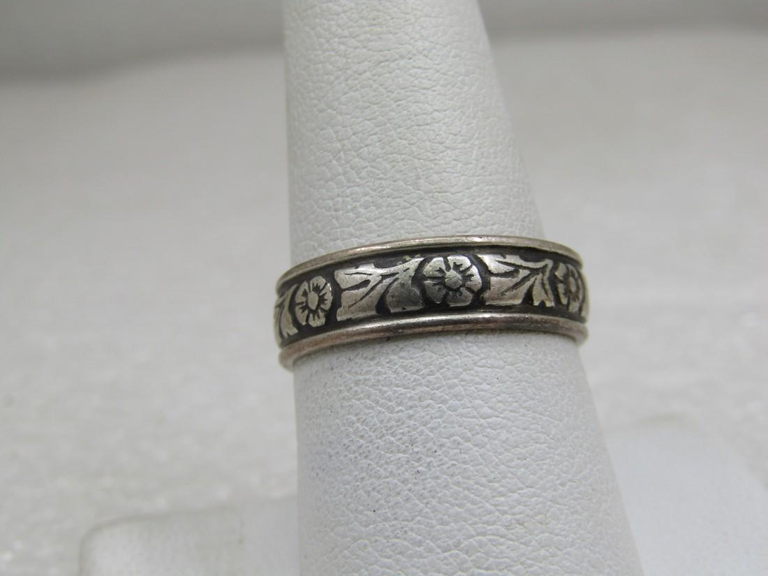 Vintage Sterling Floral Scrolled Band, Ring, Sz. 8.5, 5.5mm Signed: Vintage Sterling Floral Scrolled Band, Ring, Sz. 8.5, 5.5mm Signed with an unknown maker's mark. Age is estimated at 1940's-1950's. Floral blossoms around the ring with stem and leaves between each bl