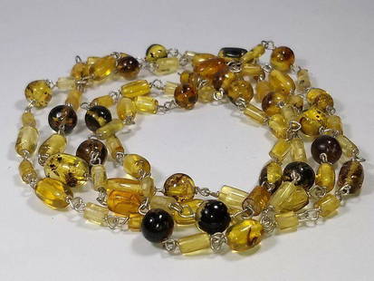 Alberto Juan Mexican Handmade Sterling Silver Amber Beaded Necklace: This Alberto Juan one of a kind necklace was handmade from sterling silver and orange and yellow amber. Amber beads are 22 carats. This necklace measures 43" long and 0.19" wide. The amber was sourced