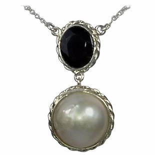 Alberto Juan Mexican Handmade Sterling Silver Mabe Pearl and Red Garnet Necklace: This Alberto Juan one of a kind necklace was handmade from sterling silver, oval faceted red garnet (4.5 carats), and a mabe pearl (9.5 carats). The chain and findings used in this piece are sterling