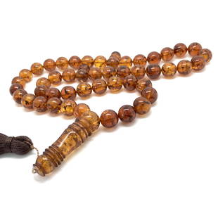 Amazing Amber Tesbih made from Round Amber beads: Title: Amazing Amber Tesbih made from Round Amber beadsMetal Purity: NoneGemstone: AmberWeight: 52.45 gSize: Bead size: 11.8 mm Bead size: 0.465 inches Made of: Reconstituted AmberAdditional