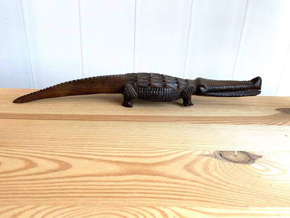 Crocodile Carved from Wood: Title: Crocodile Carved from WoodMaker: UnknownOrigin: SenegalDate/Period: UnknownMaterials: WoodSize:Size: 35 x 9 x 5 cmDescription: Crocodile Carved from WoodSize: 35 x 9 x 5 cmTail is