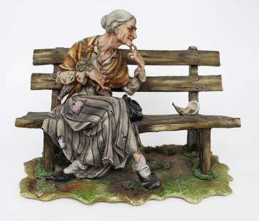 Capodimonte Lady Tramp on Bench: Capodimonte Lady Tramp on Bench Made in Italy, c.1970. Finely modelled with lots of detail; richly hand painted. Measures 25 x 17 x 19 (height) cm Good condition; few little chips to some