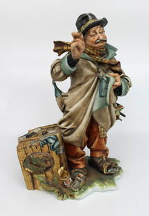 Capodimonte Tramp Patching His Coat by Tyche Bruno: Capodimonte Tramp Patching His Coat by Tyche Bruno. Capodimonte, made in Italy. Mid/late 20th century. Measures 24 x 16 x 32 (height) cm. Good condition; two chips to the umbrella poking out of his