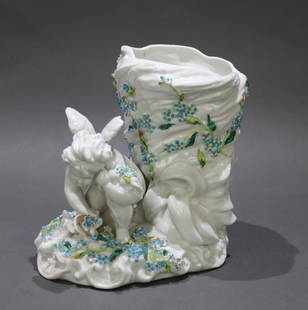 Early/Mid 20th c. Sitzendorf Cherub Vase: Early/mid 20th century German porcelain. Sitzendorf. Cherub with sickle collecting flowers. White to the whole with colour to the flowers & sickle. Height: 20 cm. Good condition, minor wear to some