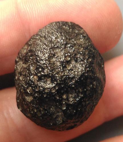 PHILIPPINITE TEKTITE - FROM METEORITE IMPACT: Title: PHILIPPINITE TEKTITE - FROM METEORITE IMPACT Origin: Hukawang Valley, Kachin State, Myanmar Size: 2.5x2x1 cm / 5 gram Description: rounded & flattened philippinite tektite cookie. glossy & perf