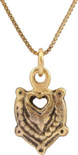 RARE ANCIENT VIKING HEART PENDANT NECKLACE, C.850-1050 AD: Classic heart form. 5/8" height plus the suspension loop. Central high relief heart in its fully evolved form with cusped top, and beaded surround. The cusp bridged with another forming a pierced