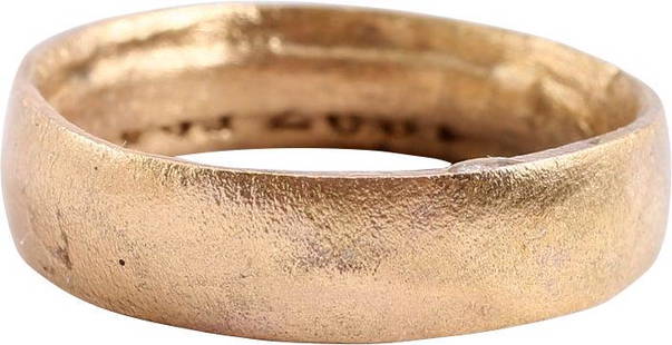 VIKING WARRIOR'S WEDDING RING, SIZE 9 1/4: 9th-11th century AD. Gilt bronze, size 9 1/4. Wide 5.5mm band with a low rounded face. The inside with distinct tool marks from the removal of the central core after casting, including a short series