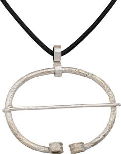 VIKING PROTECTIVE BROOCH, 850-1050 AD: About 1 5/8" width (1.66"), oval form with the ends reeded and curled. Original cross pin. Worn in numbers on the leather war jerkin, at an ounce each, a few pounds could be added providing