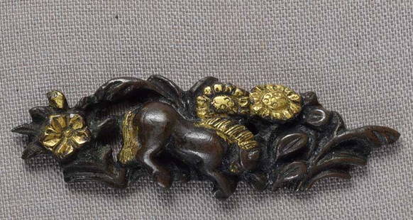 Single 19c Japanese sword MENUKI HORSE flowers: Single early 19th century menuki - Japanese sword fitting - depicting a horse grazing among flowers and grasses. Great design and detailing, beautiful dark patina, wear to gilding. Length 1 5/8