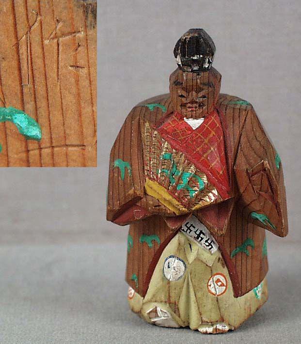Meiji saishiki netsuke SAMBASO DANCER by NARIKAZU: Meiji period (late 19th century to 1912) hinoki (cypress wood) netsuke of a sambaso dancer in characteristic posture, holding a fan and wearing Okina mask and hat used in the dance. Made in saishiki t