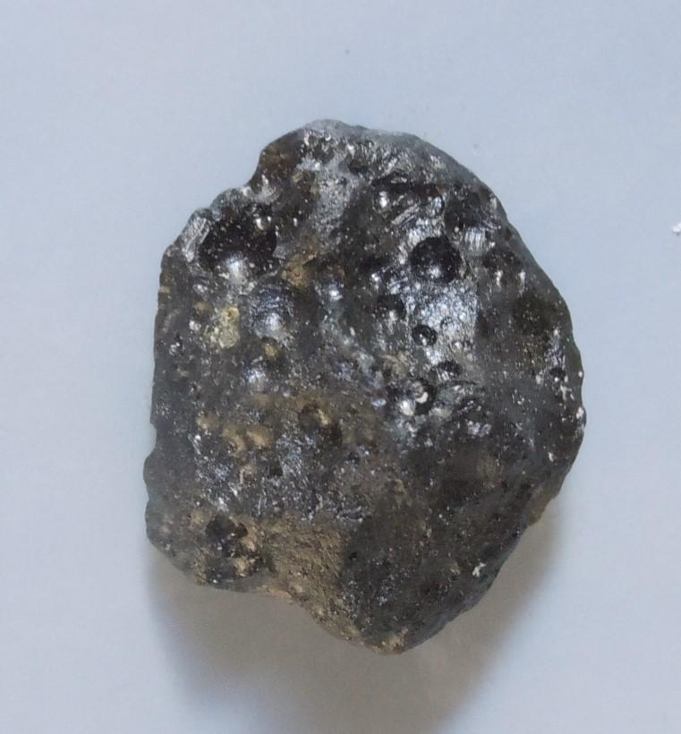 PHILIPPINITE TEKTITE - FROM METEORITE IMPACT: Title: PHILIPPINITE TEKTITE - FROM METEORITE IMPACT Origin: Paracale, Camarines Norte, Luzon, Philippines Size: 1.5x1.5x1 cm / 4 gram Description: smooth flattened philippinite tektite with irregular