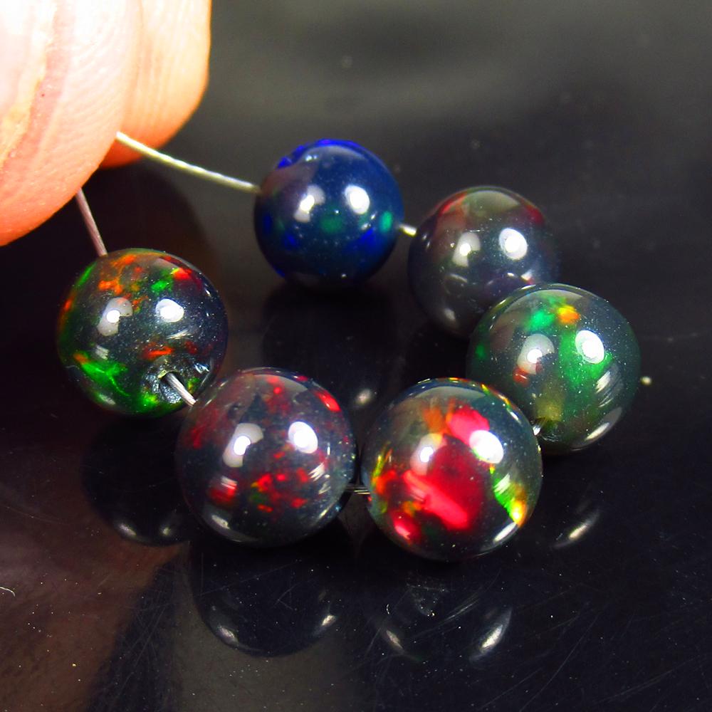 6.34 Ctw Natural 10 Drilled Black Fire Opal Ball Beads: No Reserve! Title: 6.34 Ctw Natural 10 Drilled Black Fire Opal Ball Beads Stone Clarity: Translucent Gemstones: Natural Faceted Black Opal Beads Carat Weights: 6.34 Size/Dimensions: 6.00 - 6.20 mm / 6