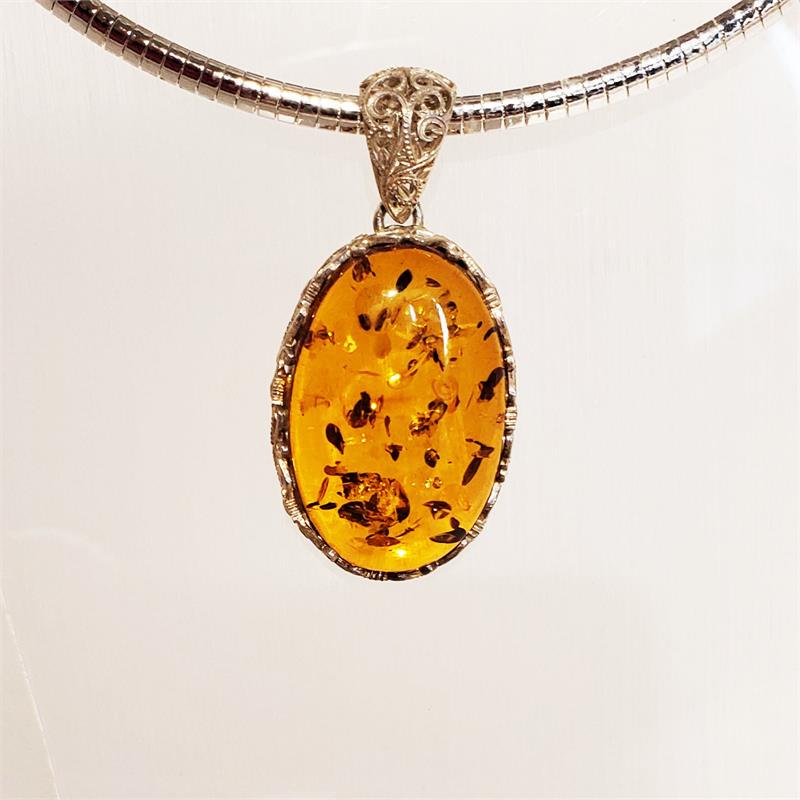 Amber Pendant With Silver Filigree: Product name: Amber Pendant With Silver Filigre Setting: Sterling Silver Stone: Genuine Baltic Amber Color: Honey Dimensions: 2.1" x 1" x 0.3" Weight: 14 grams Stamp/Mark: 925 Made in Poland Reserve: