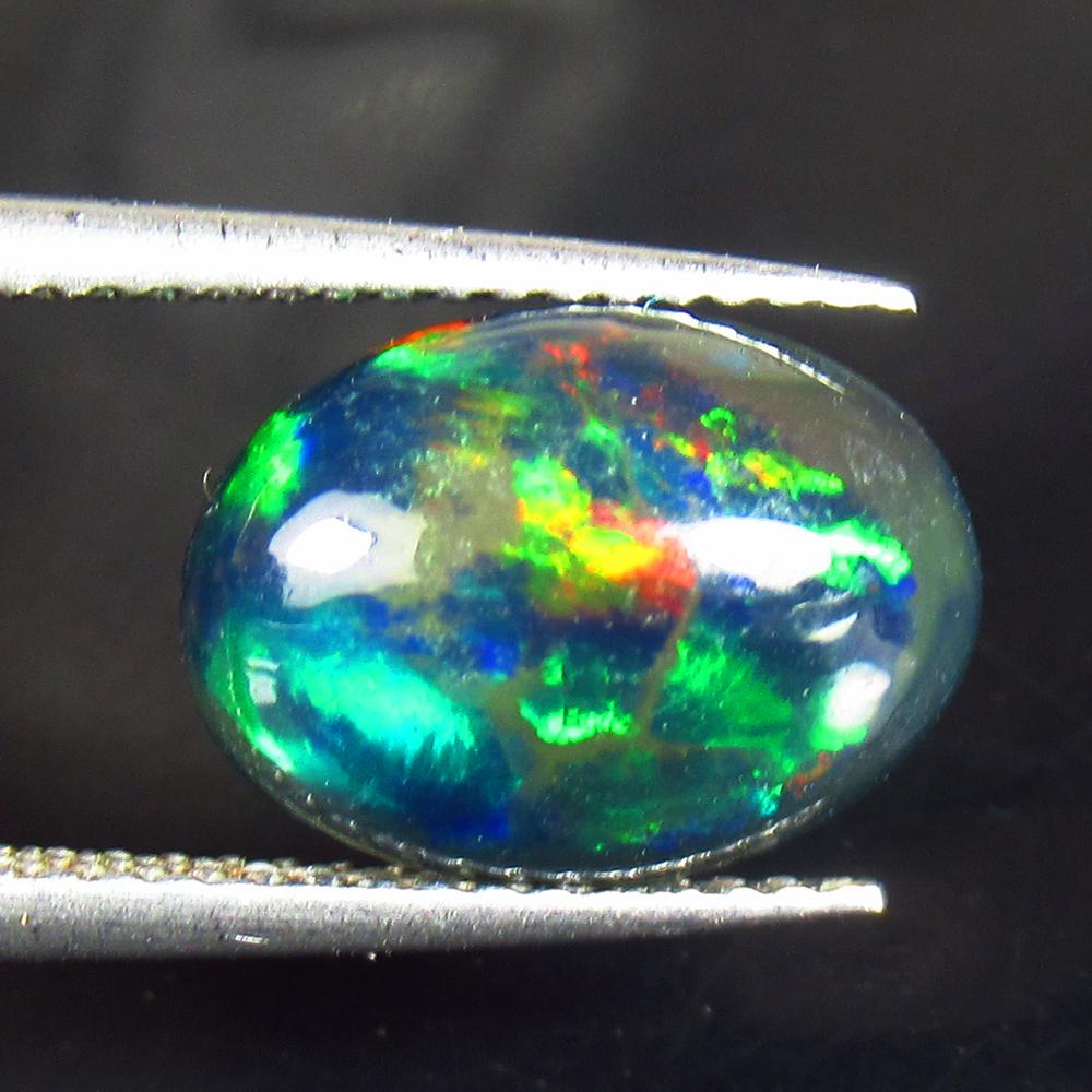 2.46 Ctw Natural Ethiopian Black Fire Opal Oval Cab: No Reserve! Title: 2.46 Ctw Natural Ethiopian Black Fire Opal Oval Cab Stone Clarity: Translucent Gemstones: Black Opal Carat Weights: 2.46 Size/Dimensions: 12.30 x 8.90 x 5.10 mm Additional Informati