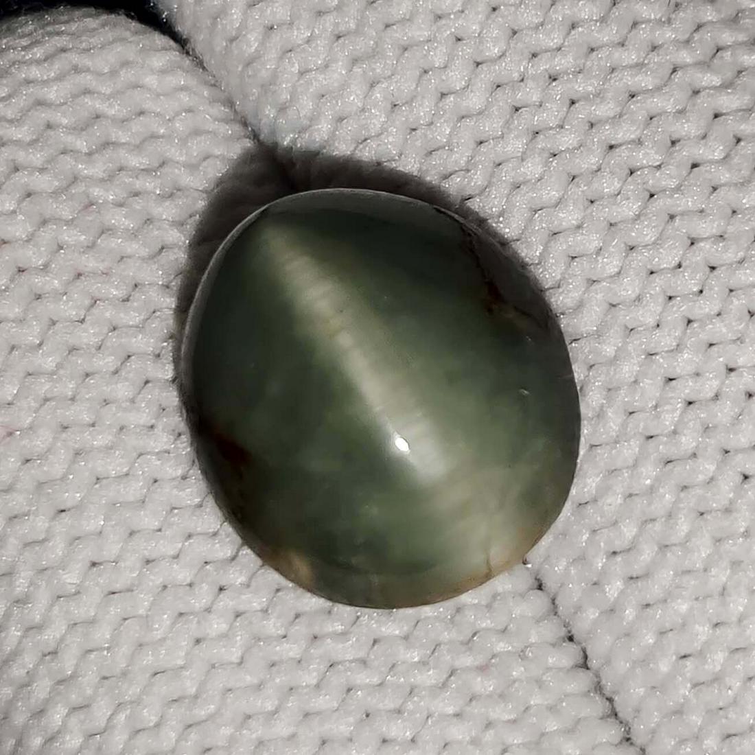 9.00 ct Certified Natural Cat's Eye: No Reserve! Title: 9.00 ct Certified Natural Cat's Eye Additional Information: Gemstones: Cat's Eye Carat Weights: 9.00 ct Color : Dyed Size/Dimensions: 13.5 X 11.5 X 8.12 mm Materials & Techniques: C