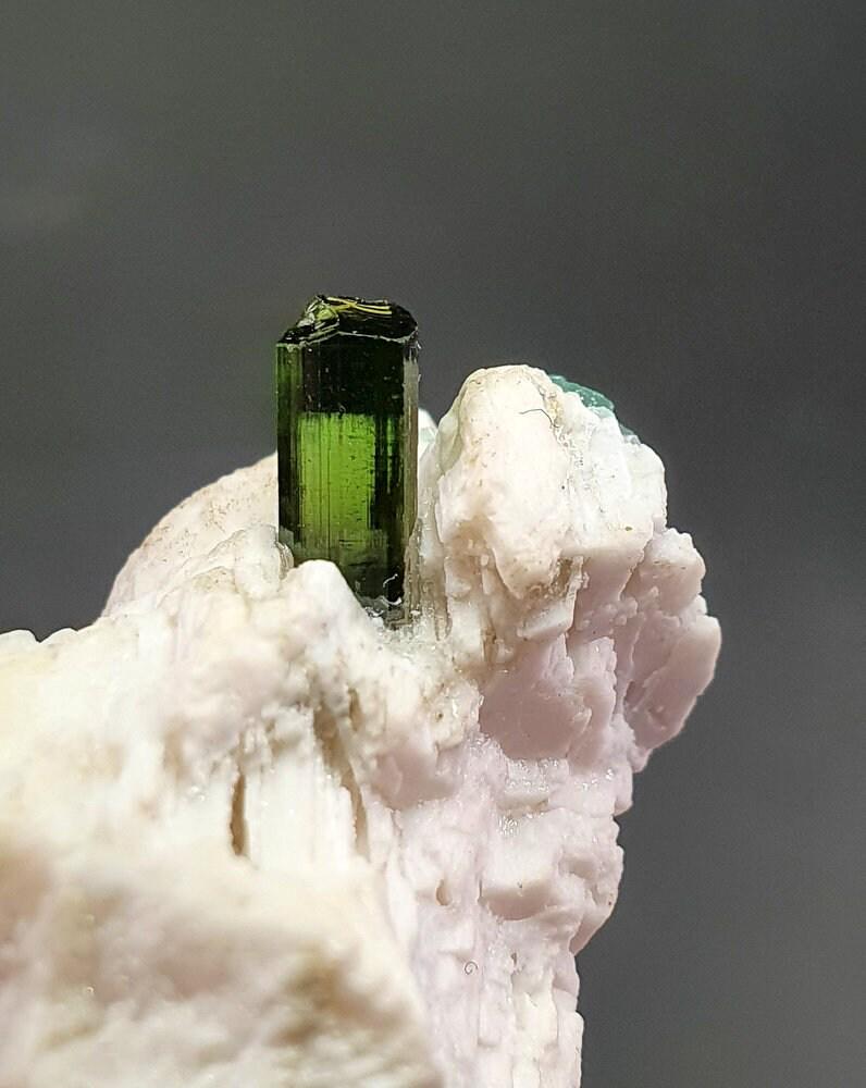 28 Grams very Beautiful Green Tourmaline on Matrix From Afghanistan: Description 28 Grams very Beautiful Green Tourmaline on Matrix From Afghanistan . Size 3.7 CM X 2.5 CM X 2.2 CM Reserve: $25.00 Shipping: Domestic: Flat-rate of $12.00 to anywhere within the contiguou
